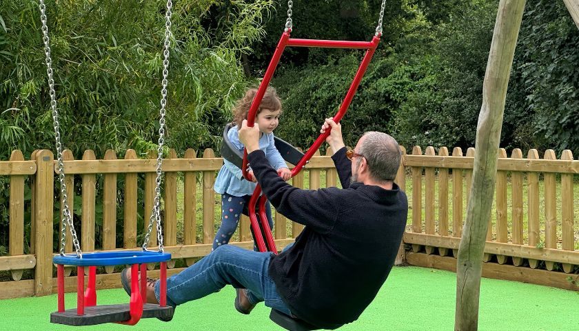 Family playing on a swing