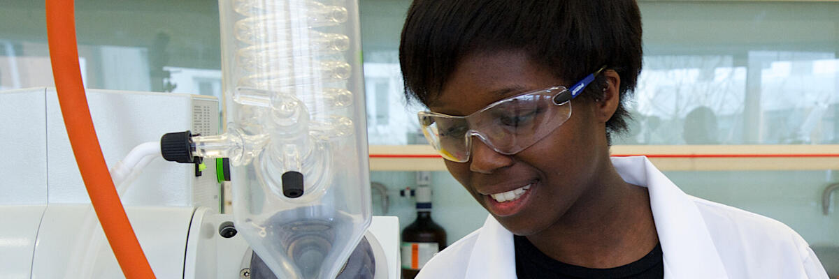 A student examining some chemistry equipment