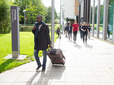 A student with a suitcase