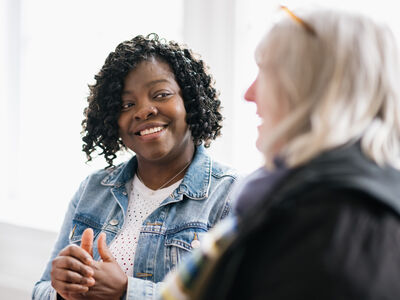 Two females sat talking 