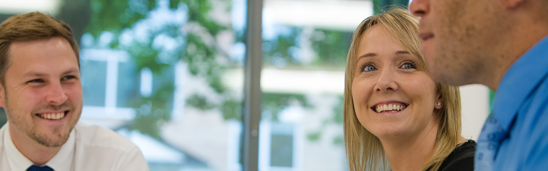 Woman smiling during a conference at Lancaster University