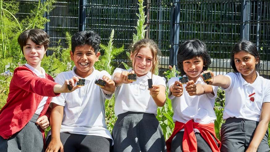 Children holding up micro:bits