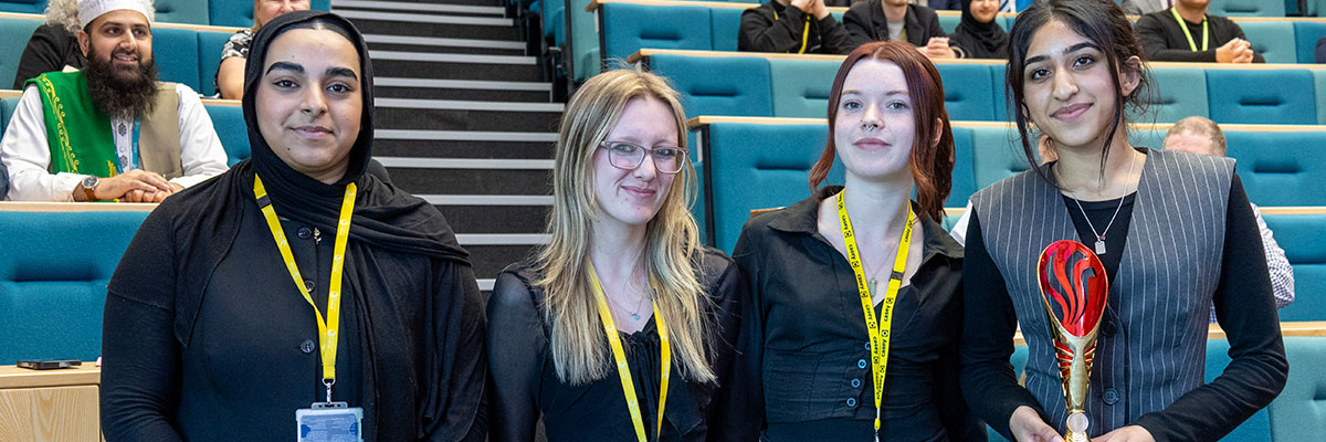 A woman standing facing a wall with ideas written on it