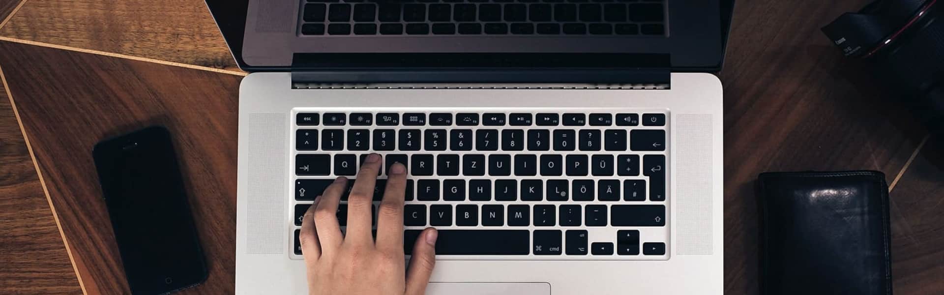 Hands typing on a laptop