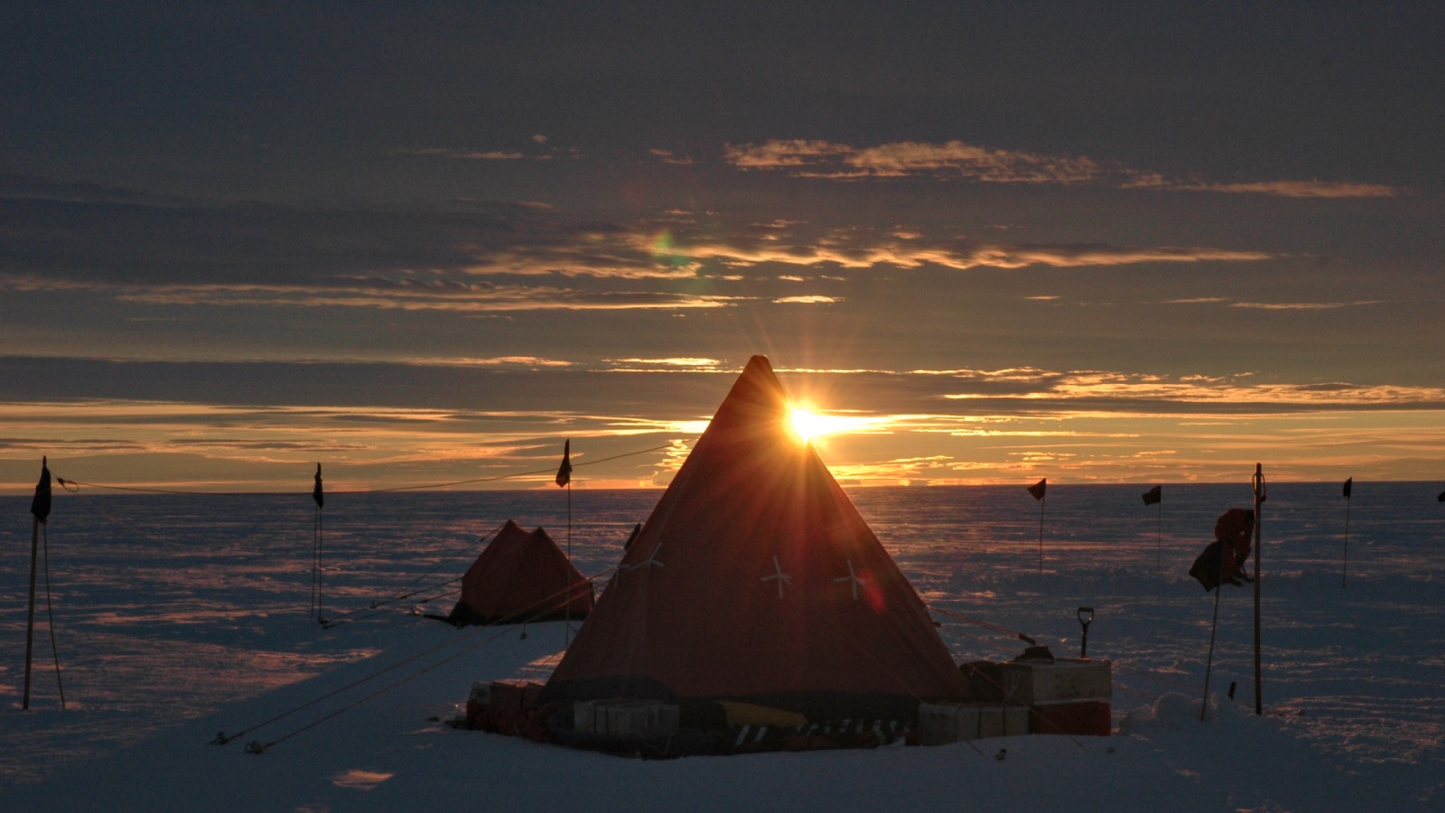 Sunset over a tent in the arctic.