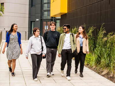 Group of students walking outside Margret fell lecture theatre