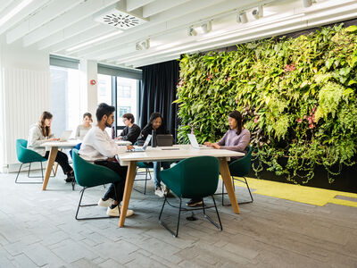 Students studying in the library next to the living wall on A floor