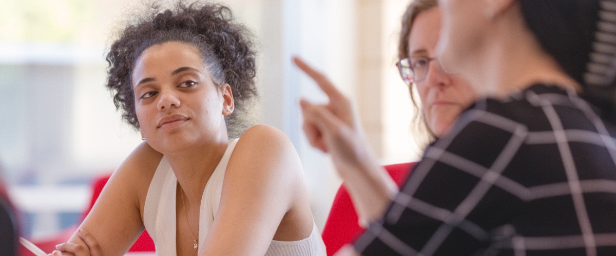 A student in the Management School pays attention to a roundtable discussion.
