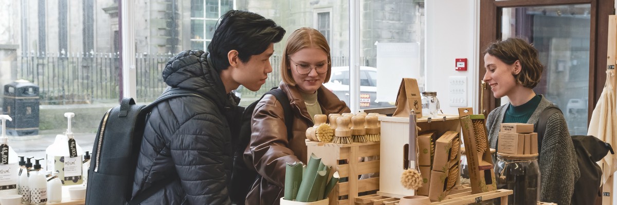 Three students shop in Lancaster city centre.