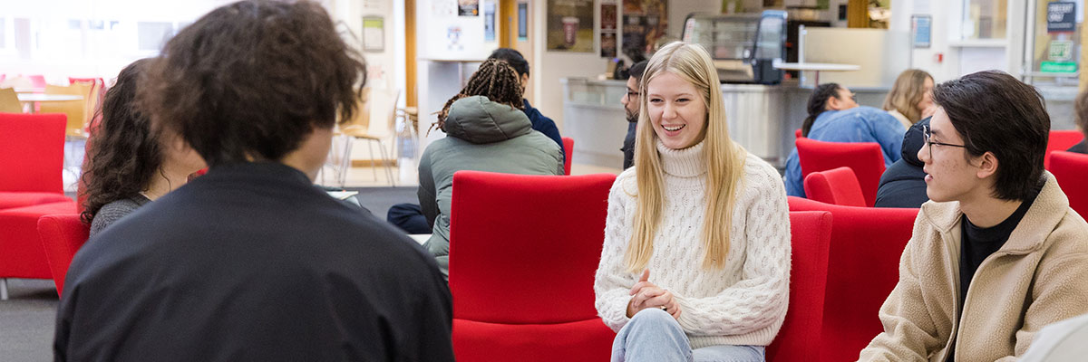 A group of students on sofas chatting