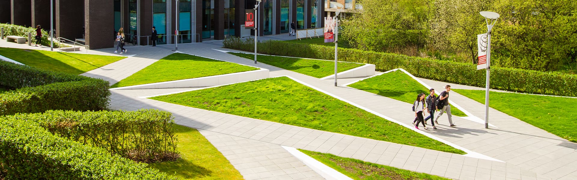 Students crossing the area in front of the Charles Carter Building