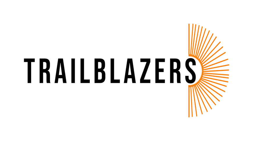 Black text that says 'Trailblazers'. next to this is a top down image of  an open book in orange